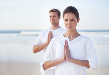 Prayer, yoga and couple on beach in morning for fitness, exercise and mindfulness in lotus pose....