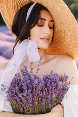 Portrait of a beautiful young woman holding violet lavender flowers