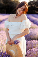 Portrait of a girl in lavender field holding violet lavender flowers