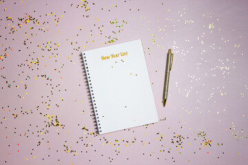 To do list concept with a blank notebook, golden pen with glitter on a pink background. 