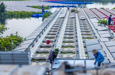 Diligent Team At Work Installing a Sustainable Future on a Floating Solar Farm