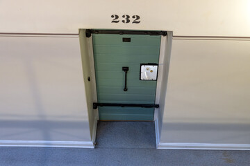 A cell door in a prison corridor
