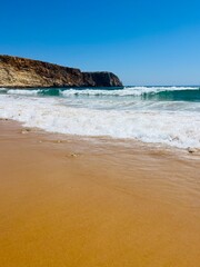 Rocky coast of the ocean bay, clear blue sky, ocean horizon, rocks