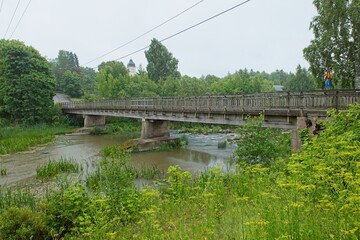 Wooden old bridge over koskenkyl&auml;njoki river in cloudy summer weather, Koskenkyl&auml;, Finland.