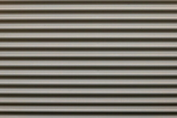 a gray corrugated iron wall in the city