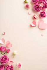Celebrate 8 March with a charming top view vertical snapshot of delicate paper hearts and vibrant rose petals scattered on a soft beige backdrop, leaving ample space for your message or advertisement