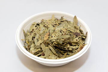 Dry tamarind leaves in bowl ingredient herb for herbal alternative medicine.