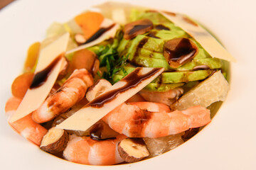 RECIPE FOR MIXED SALAD OF BOTTARGA AVOCADO SHRIMP CHINESE GRAPEFRUIT, SUCRINE SALAD, PARMESAN, HAZELNUT, BALSAMIC VINAIGRETTE. High quality photo