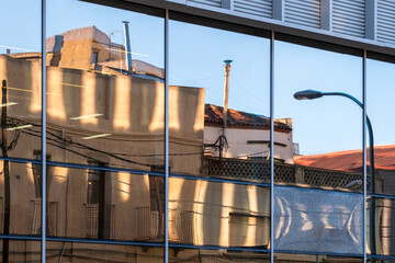 Urban reflections in a contemporary architecture facade with mirrors