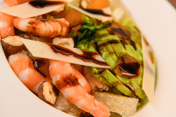 RECIPE FOR MIXED SALAD OF BOTTARGA AVOCADO SHRIMP CHINESE GRAPEFRUIT, SUCRINE SALAD, PARMESAN, HAZELNUT, BALSAMIC VINAIGRETTE. High quality photo