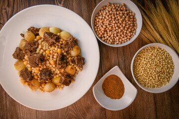 Moughrabieh is a popular dish in the Lebanese cuisine, LEBANESE RECIPE FOR MOUGHRABIEH WITH BEEF AND SMALL ONIONS, SEMOLINA PEARLS AND CHICKPEAS. High quality photo
