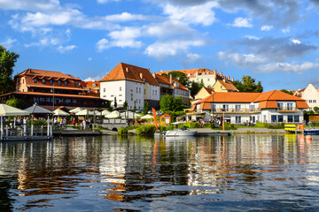 Fototapeta na wymiar View of the center of Ryn, the castle, the lake and the marina with moored boats., Masuria, Poland.