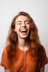 young woman smiling isolated on a white background and looking excited