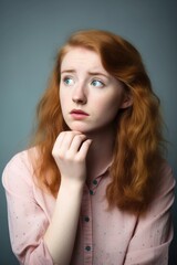 studio shot of a young woman looking worried about something