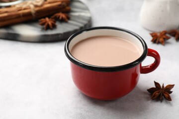 Tasty hot chocolate in cup on light table, closeup. Space for text
