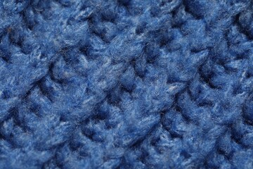 Texture of soft blue knitted fabric as background, closeup