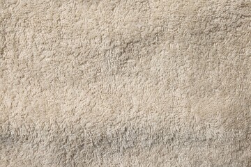 Texture of soft beige fabric as background, top view