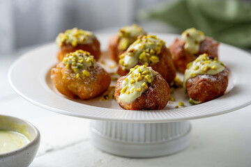 Pistachio Cream-Stuffed Fritelle on Elegant White Dish