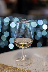 Small tasting glass of sparkling wine champagne on winter festival in December, Avenue de Champagne, Epernay, Champagne region, France