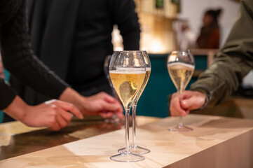 Tasting of sparkling wine champagne on winter weekend festival in December on Avenue de Champagne,...