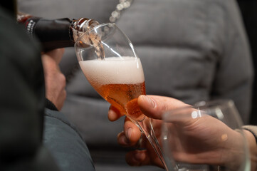 Visitors drink of sparkling wine champagne on outdoor winter festival in December on Avenue de Champagne, Epernay, Champagne region, France