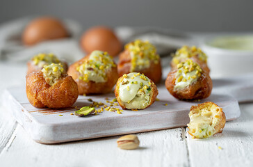 Carnival Fritelle with Pistachio Cream on Rustic Wooden Board