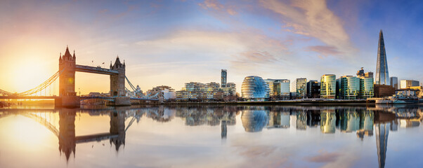 Beautiful sunrise panorama of the urban skyline of London with Tower Bridge monument and River Thames, England