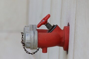 red fire hydrant mounted on the wall	
