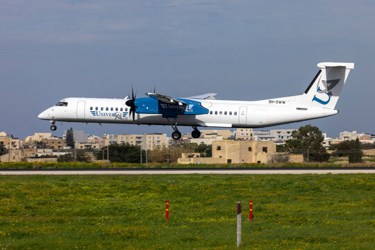Luqa, Malta - February 7, 2024: Universal Air Bombardier DHC-8-402 Q400 (Reg.: 9H-SWW) arriving from nearby Sicily, Italy.