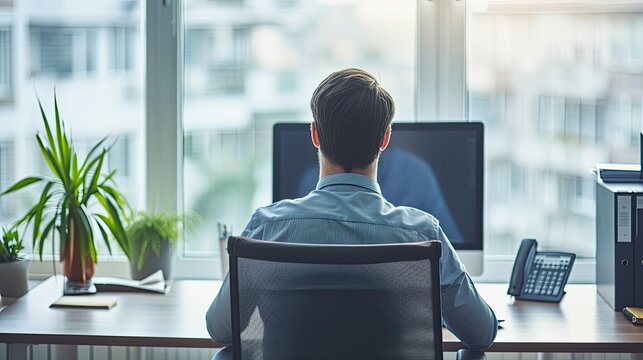 Professional Man Working at His Desk in a Bright Modern Office Environment