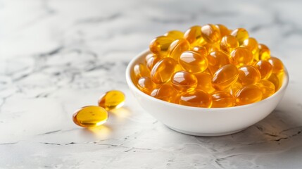 Omega 3 capsules in a white bowl on marble background