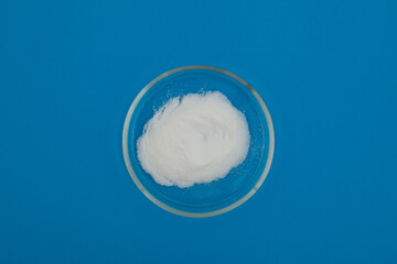 Sodium erythorbate or isoascorbate in Petri dish. Food additive E316, chemical formula C6H7NaO6. Chemically, it is the sodium salt of erythorbic acid. White crystalline powder