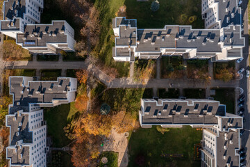 Aerial view of apartment buildings. Top down view of few apartment buildings, 
Pavement, trees and grass and trees. Typical old polish estate, Opole, autumn.