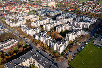 Drone view of estate, view of apartment buildings, cars, street. City architecture, suburbs Opole Mailnka, autumn.