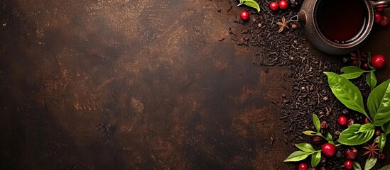 Dark brown table background with tea leaves and berries.