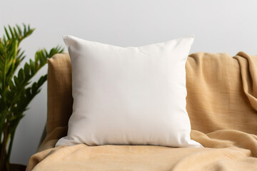Cozy living room scene with a white square pillow. Blank cushion case template for your graphic design presentation. Pillow cover mock up for print, personalized illustration. Close-up.