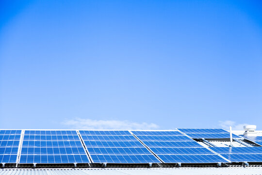 Blue sky and solar panels on building roof