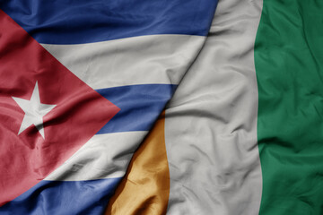 big waving national colorful flag of cote divoire and national flag of cuba .