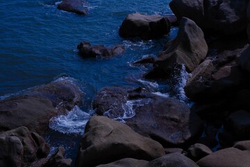 Serene blue body of water with rocky shoreline