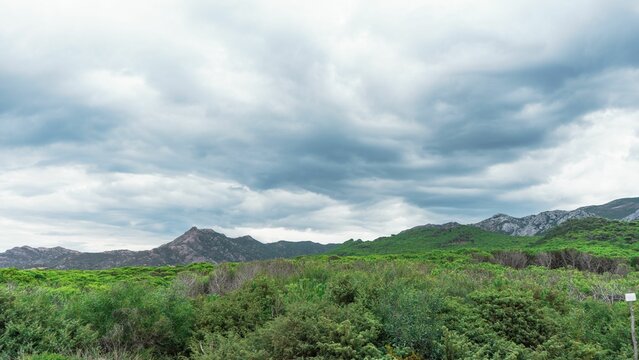 Drone shot of lush jungles and big hills under the cloudy sky