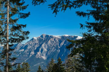 Panoramic view of majestic mountain peak Dobratsch seen from idyllic forestin on Dreilaendereck in...