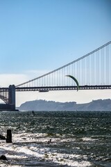 Man kite surfing in an idyllic setting near the Golden Gate Bridge bridge