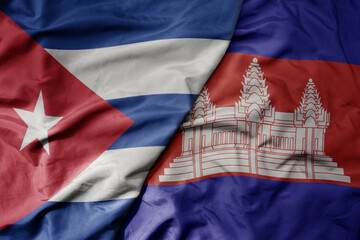 big waving national colorful flag of cambodia and national flag of cuba .