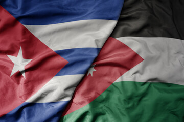 big waving national colorful flag of jordan and national flag of cuba .