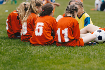 School Girls in a Soccer Team Sitting Together in a Circle. Youth Female Football Team in Summer Tournament Game