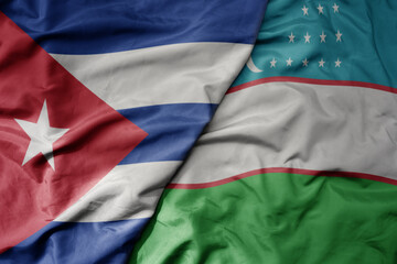 big waving national colorful flag of uzbekistan and national flag of cuba .