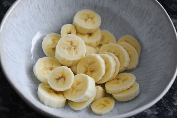 Ceramic bowl with sliced banana.