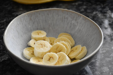 Ceramic bowl with sliced banana.