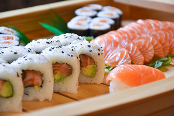 Colorful sushi set with rice. Garnish with pickled ginger and wasabi. Rolled sushi with avocado, mushrooms, tuna, salmon and sesame. With red caviar. Japanese food