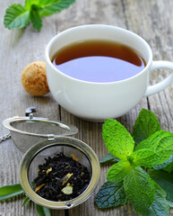 natural tea dry and in a cup on a wooden table